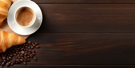 Coffee with french croissant, breakfast background. Cup of coffee on dark brown wooden table, top view. Caffeine backdrop