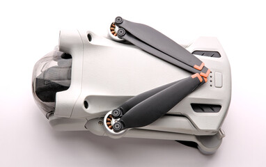 drone folded up (small recreational aircraft quad copter that shoots 4k video) isolated on white background (close up, macro, cut out)