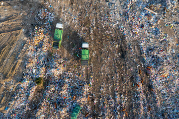 Aerial view of garbage truck unload pile of waste at landfill with cows. Dump of unsorted waste garbage pile in trash dump. Environmental pollution and ecological disaster. View from drone - 762483732