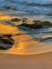 Golden Shores: Sunset Illuminating the Seaside Rocks