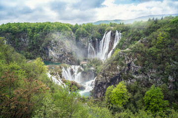 Fototapeta na wymiar Amazing aerial view of Plitvice national park with lakes and picturesque waterfalls in a green spring forest, Croatia.