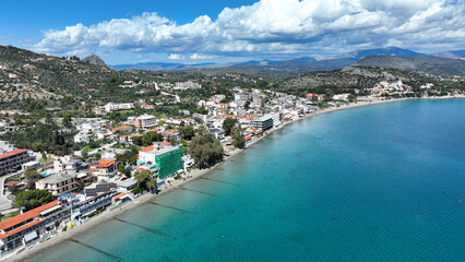Aerial drone photo of famous seaside village small port and long sandy beach of Tolo with hotels and resorts built by the sea, Argolida, Peloponnese, Greece