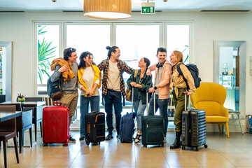 Young group of tourists with suitcases arriving at youth hostel guest house - Happy friends...