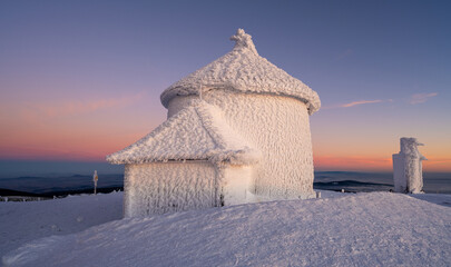 chapel on Sniezka peak during sunset in winter time in Giant mountains 