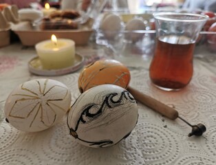 The process of painting eggs with wax.Colored eggs