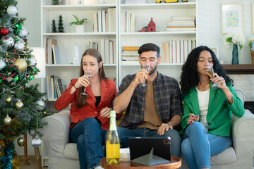 Multiethnic friends had fun party and drinking wine at home.