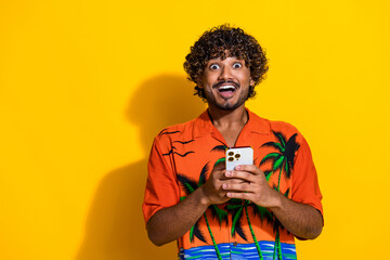 Portrait of ecstatic guy with afro hair wear shirt impressed by fast internet connection on...