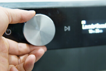 a person manipulating a washer dryer