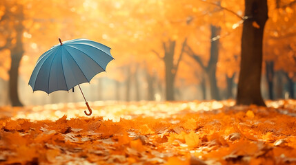 a blue umbrella sitting in a field of leaves