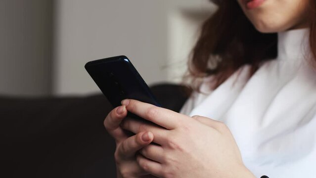 Close up of caucasian female hands holding smartphone. Happy female enjoy online chat, internet purchase, browse web, download new cool freeware application. Modern wireless tech user concept