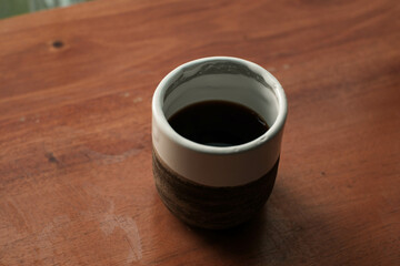 V60 filter coffee in an aesthetic ceramic cup on a wooden table