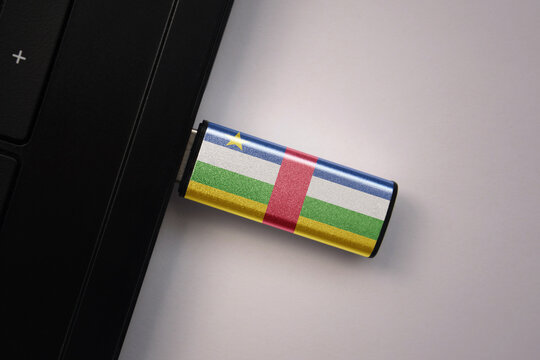 usb flash drive in notebook computer with the national flag of central african republic on gray background. - Powered by Adobe