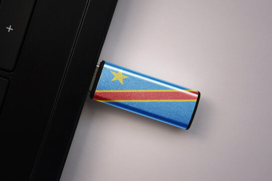 usb flash drive in notebook computer with the national flag of democratic republic of the congo on gray background. - Powered by Adobe