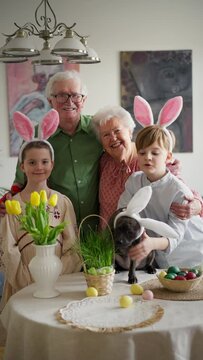Easter video of grandparents with grandchildren before traditional easter lunch. Recreating family traditions and customs. Happy easter.