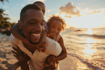 Young father giving his daughter a piggyback ride on a beautiful beach at sunset - obrazy, fototapety, plakaty