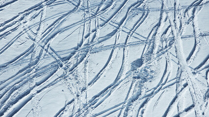 Off-piste skiing after heavy snowfall. Textures and snow tracks from skiers and snowboarders. 