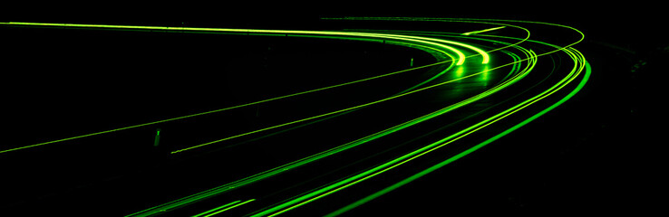 green car lights at night. long exposure