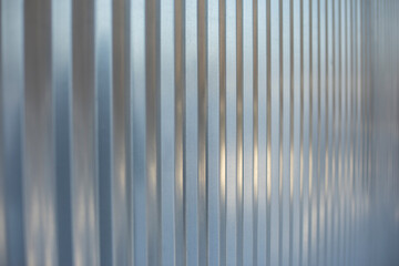 Steel fence. Metal profile sheet. Ribbed surface of the fence.