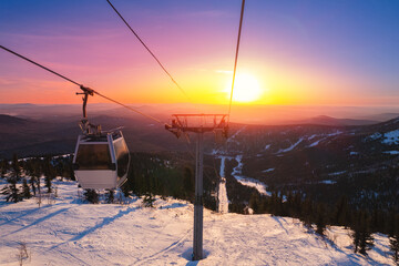 Landscape ski lift resort with snowy forest on mountain in winter sunlight, Sheregesh, Kemerovo...
