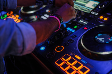DJ hands playing bollywood music in a nightclub. Concept: vinyl, mixing music, fun, nightlife