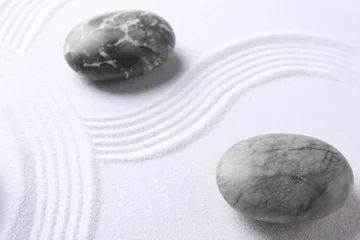 Tuinposter Stones on sand with pattern. Zen concept © New Africa