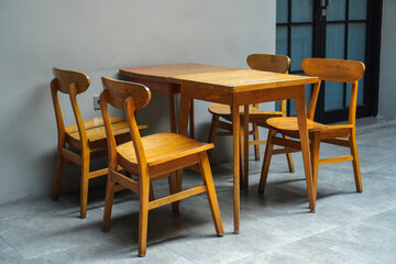 simple minimalist wooden table and chairs for sitting and drinking coffee in a coffee shop