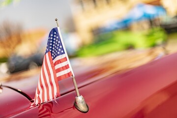 American Flag on the Hood of a Red Car