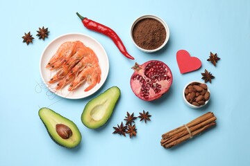 Natural aphrodisiac. Different products and paper heart on light blue background, flat lay