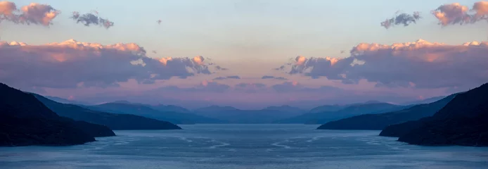 Papier Peint photo Destinations Beautiful panorama of the sea and mountains with blue water and purple clouds on the sky at the sunset.