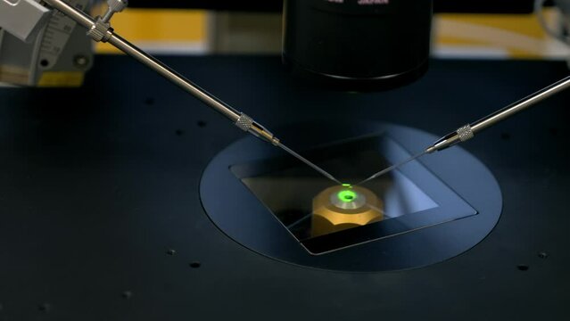 Operating the microscope needles for artificial fertilization at the clinic lab. Putting microscope needles into human egg for fertilization. Microscope needles used for recreation of fertilization.