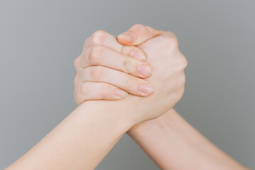 strong handshake gesture, we are together, made up of the hands of two people, two young sisters
