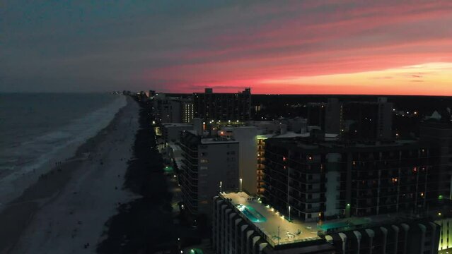Aerial view of Myrtle Beach coastline and buildings from drone at sunset, South Carolina