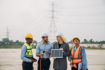 A group of construction workers are standing around a solar panel