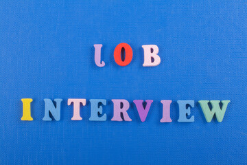 JOP INTERVIEW word on blue background composed from colorful abc alphabet block wooden letters, copy space for ad text. Learning english concept.