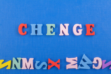 CHENGE word on blue background composed from colorful abc alphabet block wooden letters, copy space for ad text. Learning english concept.