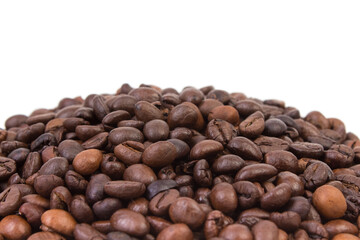 Pile of coffee beans in the center of a white table. Front view. Horizontal composition.