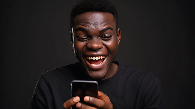 Man Laughing While Looking at His Cell Phone