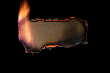 burning paper, glowing edge of paper on a black background