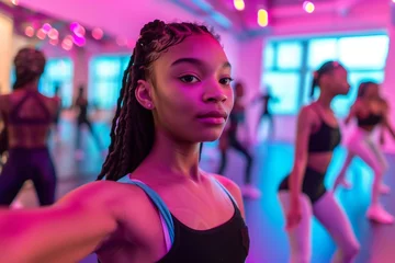 Photo sur Plexiglas École de danse Black teen girl dancer taking selfie during a dancing class in the studio with pink neon lights.