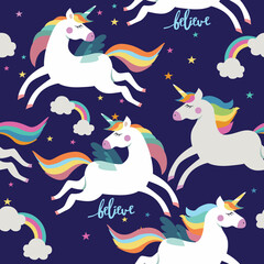 Seamless pattern with unicorns and rainbows on blue background. 