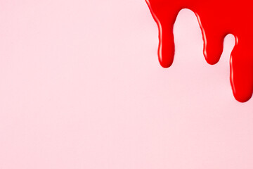 Blood on pink background. First menstrual period concept