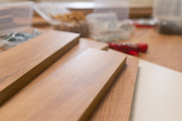 A scattered array of woodworking tools and materials on a wooden surface