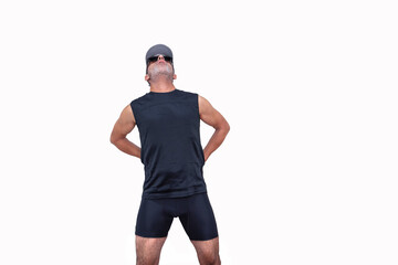 A middle-aged man with an athletic body and dressed in sports clothing, with pain in his lower back. Isolated on a white background.