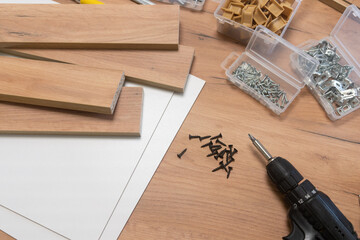 A scattered array of woodworking tools and materials on a wooden surface