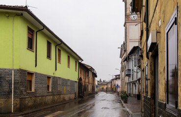 Empty street with historic buildings in a small Italian village on a rainy day