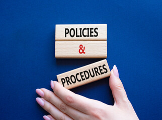 Policies and Procedures symbol. Concept words Policies and Procedures on wooden blocks. Beautiful deep blue background. Businessman hand. Business and Policies and Procedures concept. Copy space.