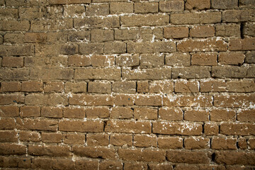 Brick wall in brown mud. Seamless texture