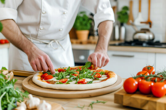 Chef makes pizza with arugula and tomatoes