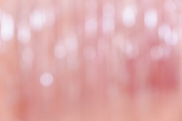 Abstract pink defocused background with light bokeh. Festive, holiday or anniversary party concept. Decorative wallpaper, feminine style