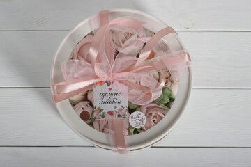 Marshmallows in a box with a transparent lid. The box is tied with a ribbon. The inscription in Russian is "Made with love". Tulips made of marshmallows.  Homemade marshmallows.